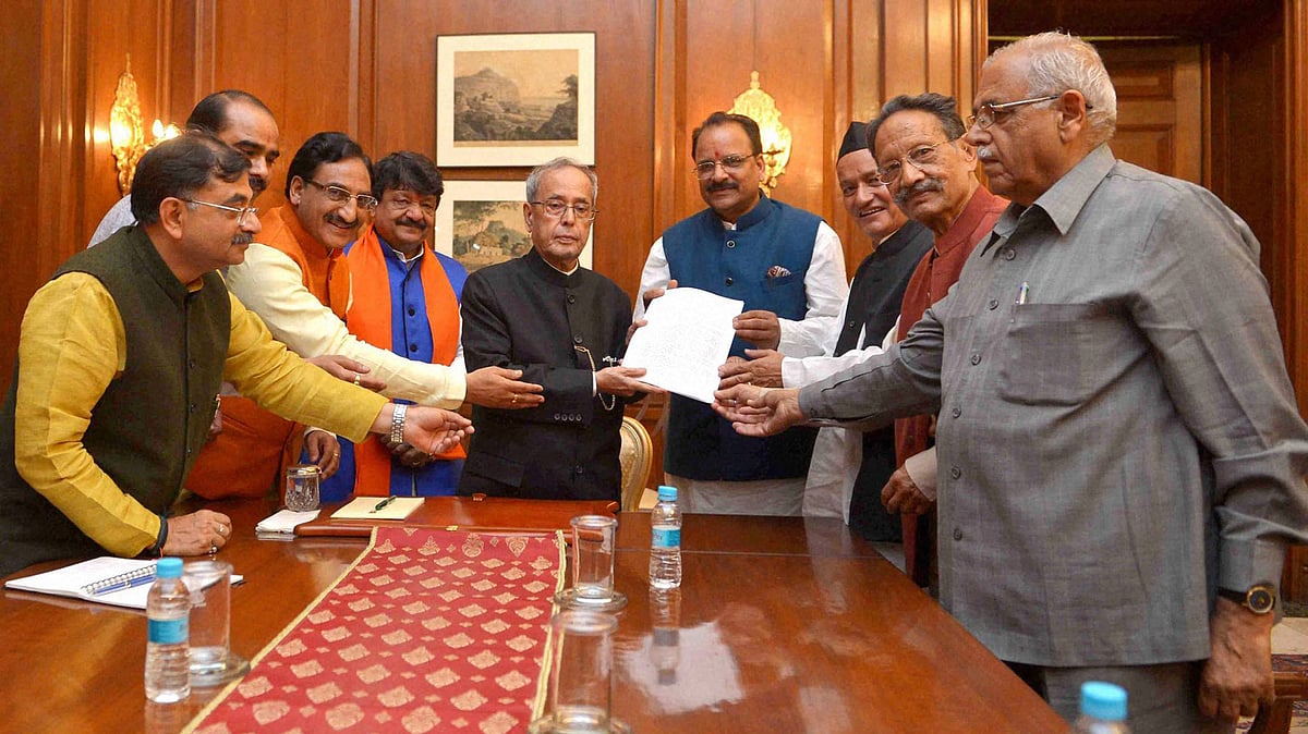 File photo of President Pranab Mukherjee receiving a memorandum from a delegation of BJP MPs and MLAs from Uttarakhand. (Photo: PTI)&nbsp;