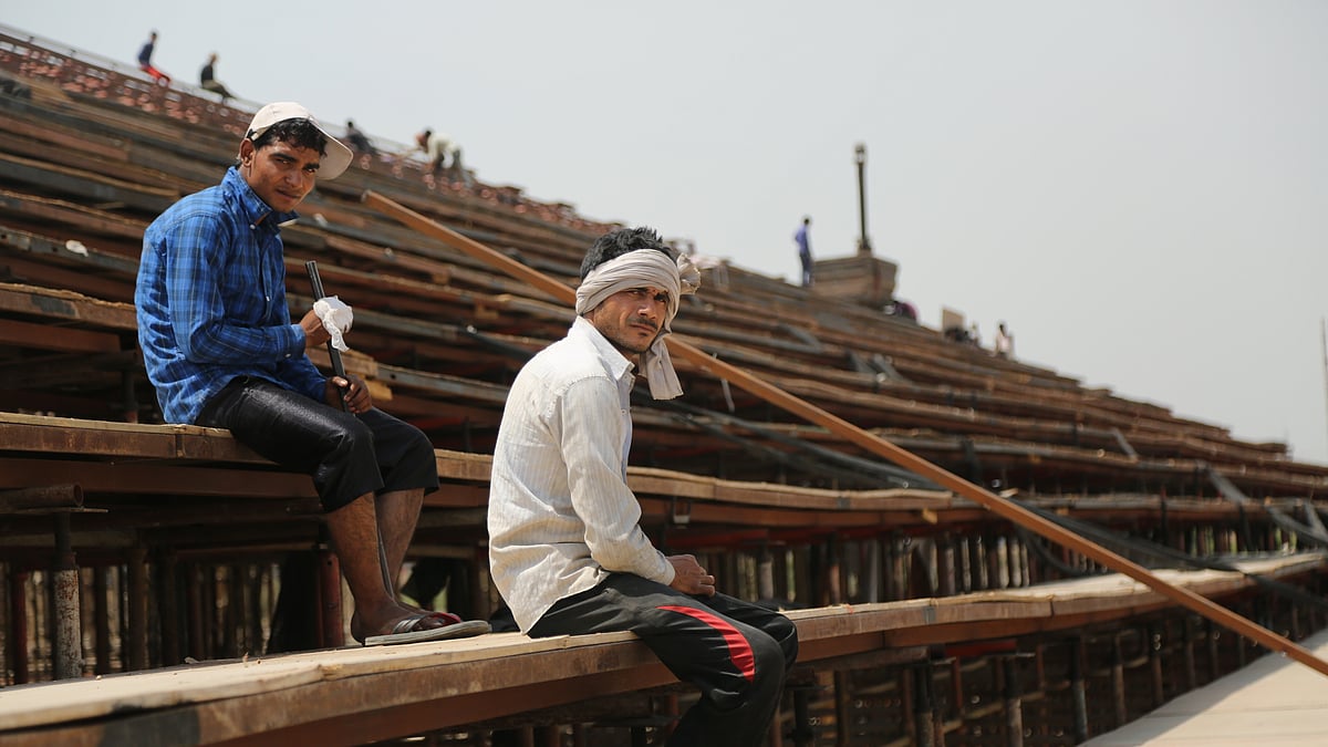 Workers sit on the stage of the World Culture Festival (Photo: Siddharth Safaya)