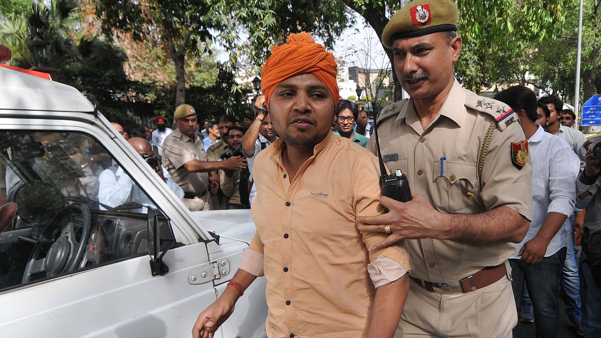 A Hindu Sena activist being taken away by police from the venue of music launch of “Ghar Wapsi”, where Pakistani singer Ghulam Ali was invited in Delhi (Photo: IANS)