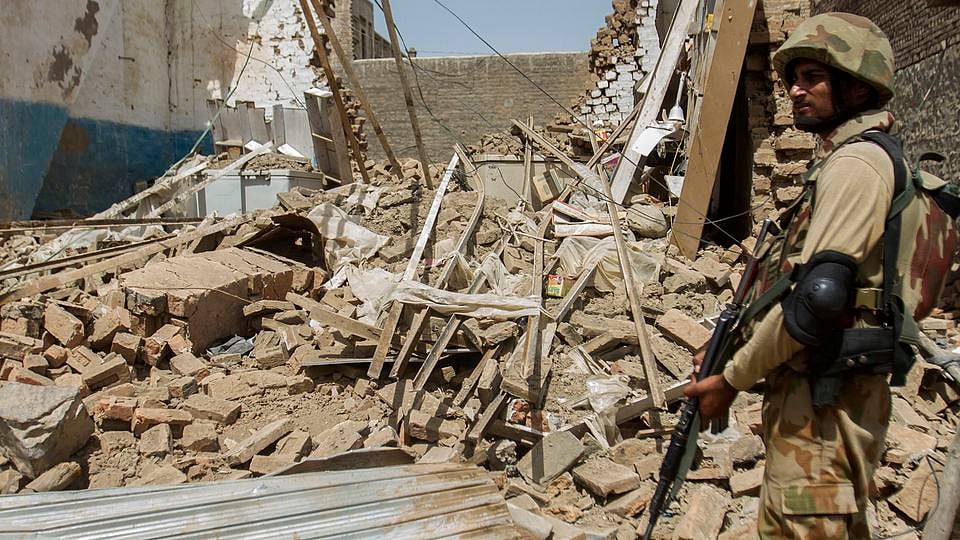 A Pakistani soldier stands beside a house which was destroyed during a military operation against Taliban militants, in North Waziristan (Photo: Reuters)