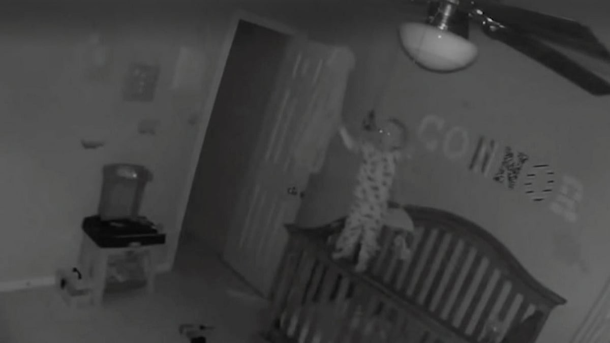 Cranky baby climbs up the side of his crib to reach his mother and falls while balancing on the ledge. (Photo: AP screengrab)