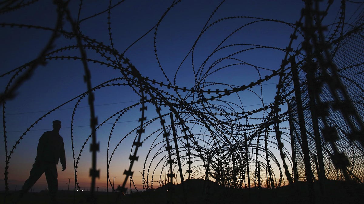 A soldier walks past concertina wire surrounding the outside of Joint Task Force Guantanamo’s Camp Delta at the U.S. Naval Base in Guantanamo Bay, Cuba.(Photo: Reuters)