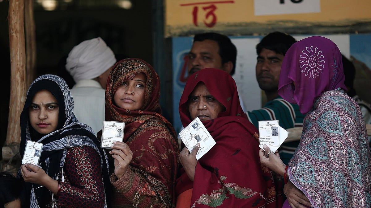 File photo of women showing their voter id cards before polling. (Photo: Reuters)