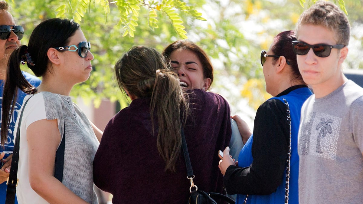 Relatives of passengers on EgyptAir flight MS804 grieve as they leave the in-flight service building at Cairo International Airport. (Photo: AP)