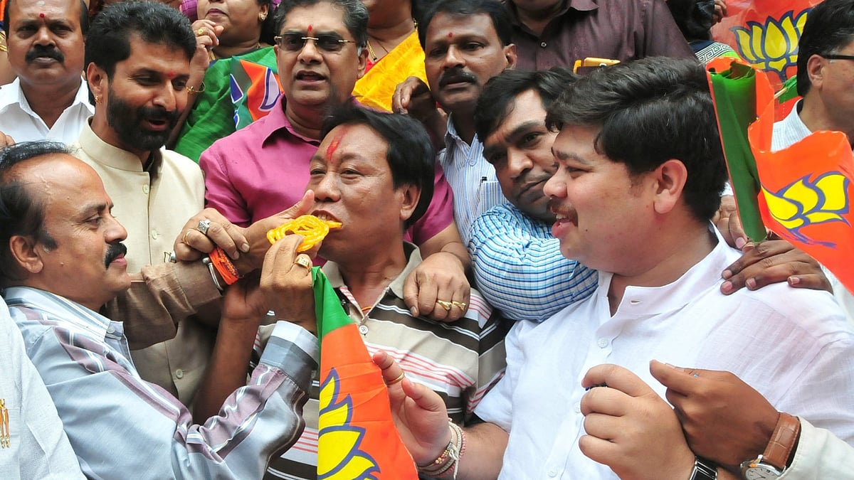 BJP workers celebrate their party’s victory in the recently concluded Assam assembly polls, in Bengaluru, on May 19, 2016. (Photo: IANS)