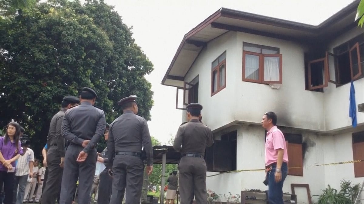 Police officials at the boarding school in Chiang Rai, Thailand, where 18 school girls were killed in a fire. (Photo: AP/TPBS screengrab)