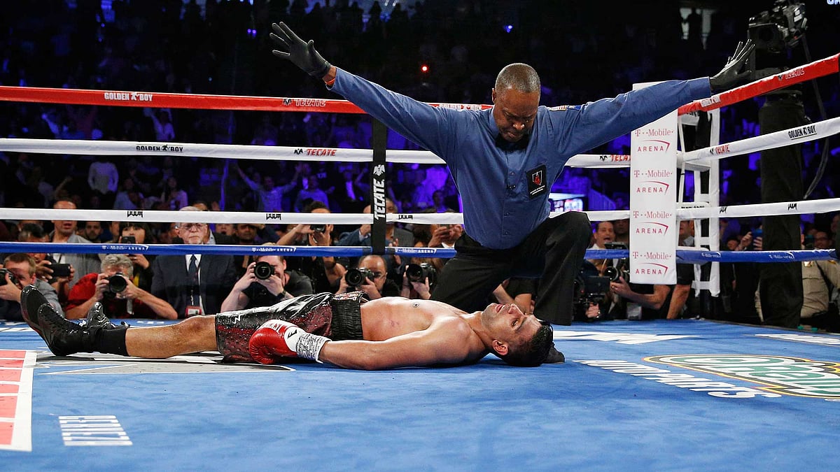 Referee Kenny Bayless calls the fight after Canelo Alvarez knocked out Amir Khan during their WBC middleweight title fight Saturday. (Photo: AP)