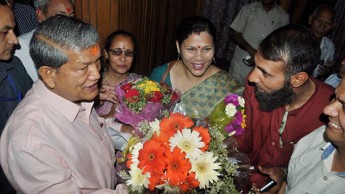 Congress leader Harish Rawat is greeted by party workers in Dehradun on Wednesday after the Supreme Court approved that Rawat won the trial of strength in the Uttarakhand Assembly. (Photo: PTI)