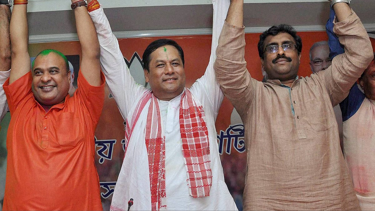  BJP chief ministerial candidate Sarbananda Sonowal (centre) along with Senior BJP leaders Ram Madhav (right) and Himanta Biswa Sarma (left) celebrating the partys thumping win the Assam Assembly polls, BJP Party head office in Guwahati on Thursday. (Photo: PTI)