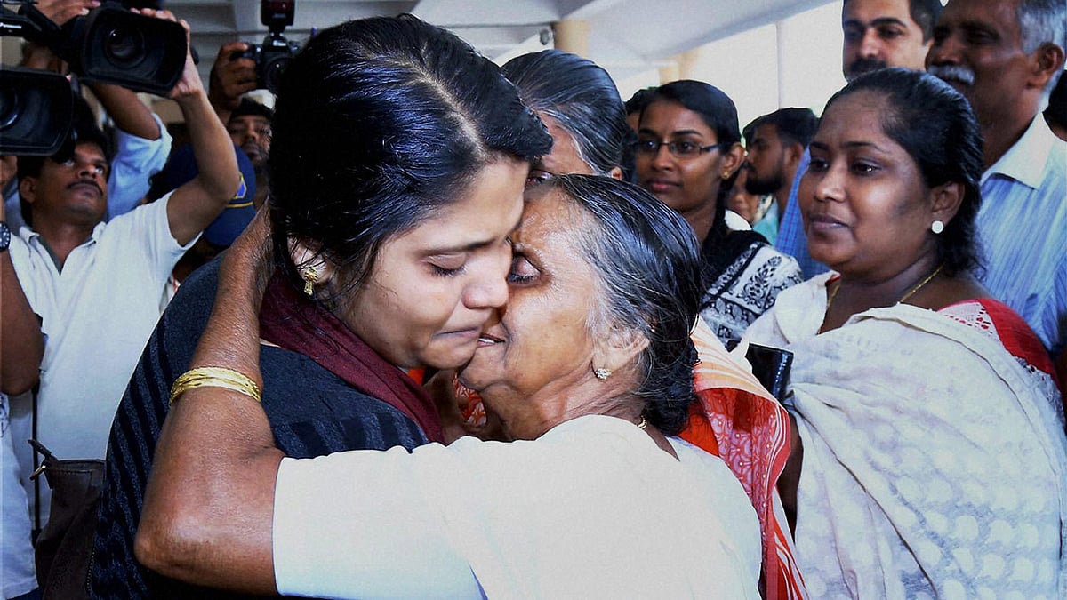 The first batch of 18 Keralites, evacuated from Libya, uniting with their families and relatives on their arrival at Kochi International Airport on Thursday. (Photo: PTI)