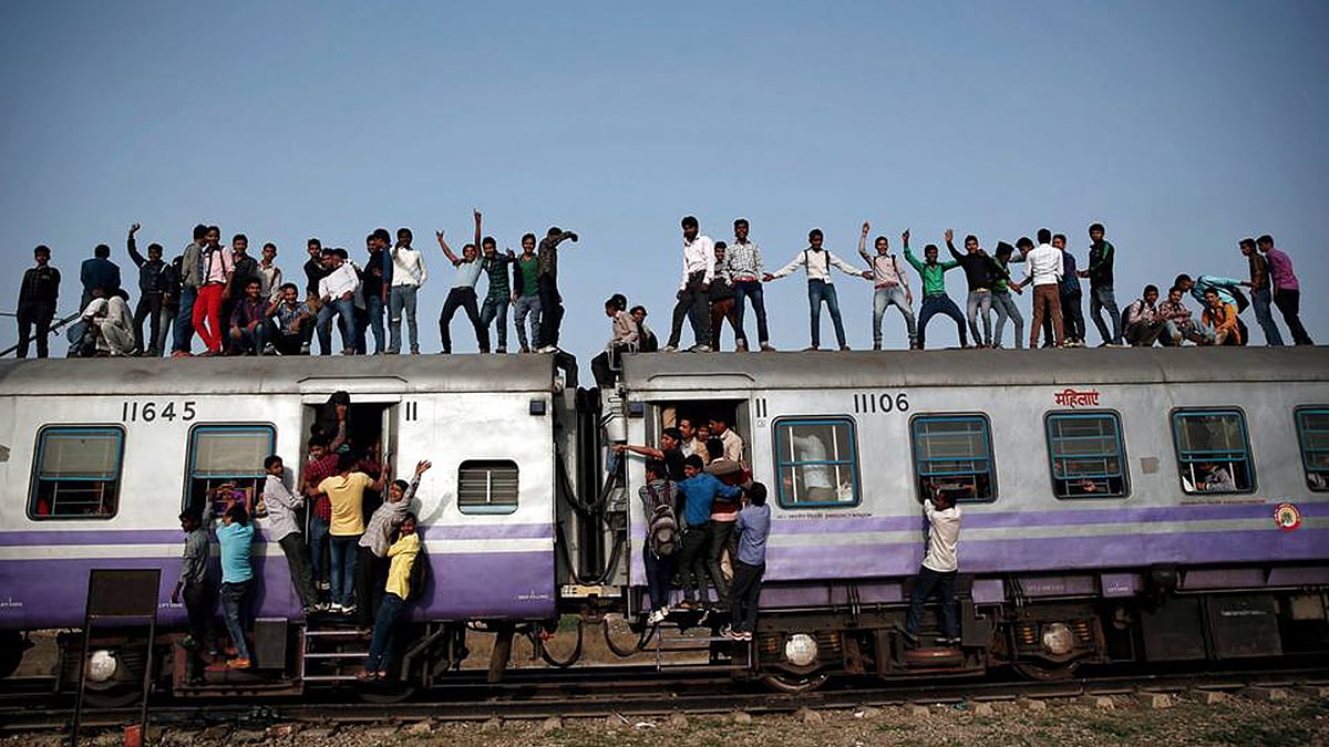 Passengers travel on an overcrowded train on the outskirts of New Delhi. (Photo: Reuters/Ahmad Masood)