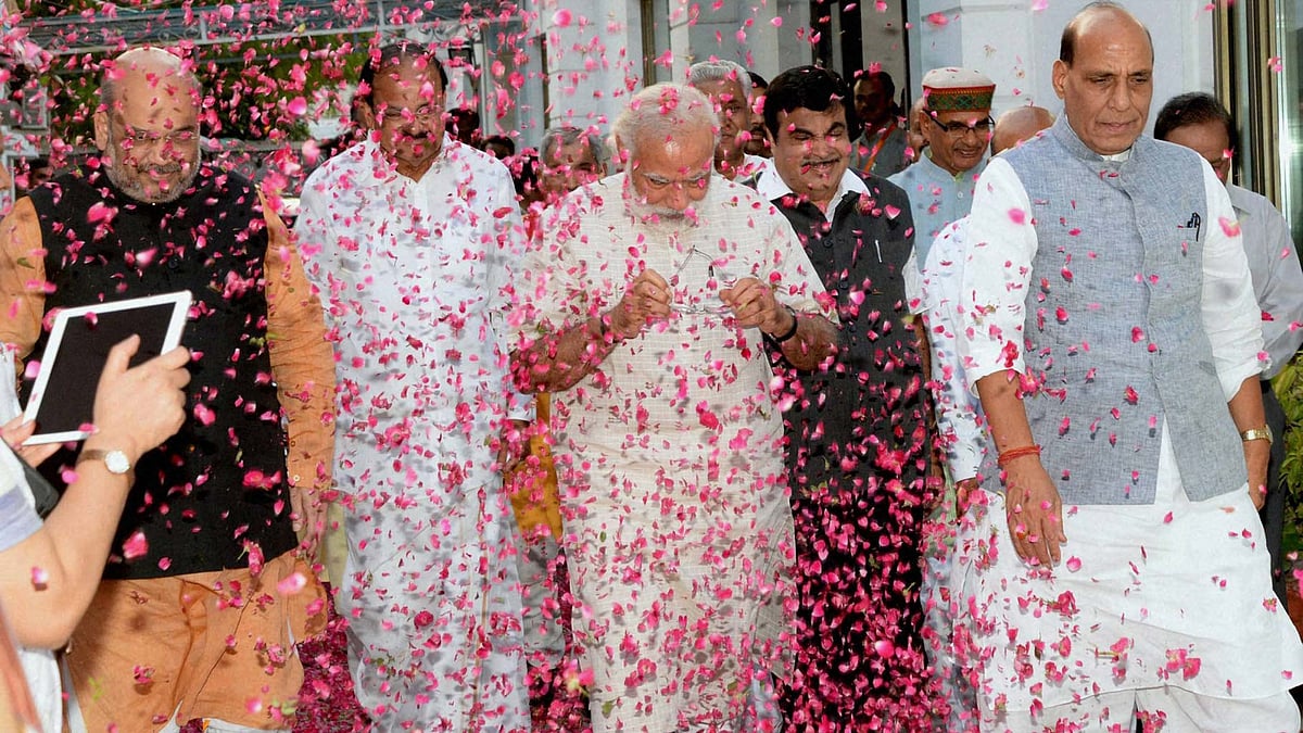 BJP workers shower flower petals on Prime Minister Narendra Modi, BJP president Amit Shah and senior leaders Rajnath Singh and M Venkaiah Naidu at the party office in New Delhi on Thursday, 19 May 2016. (Photo: PTI)