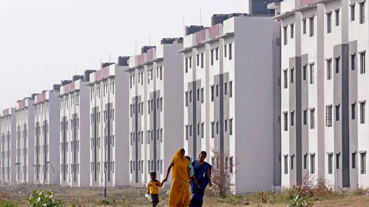 Residents walk past a block of state-funded flats for slum dwellers in the western Indian city of Surat. (Photo: Reuters)
