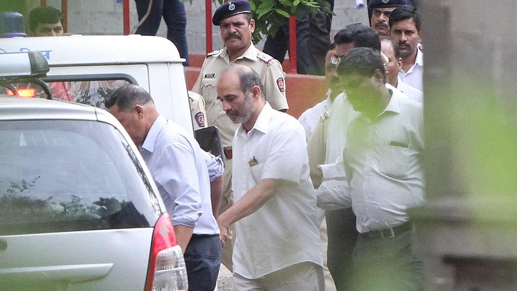 

Rightwing activist Virendra S Tawde being taken away after produced before the Sessions Court for alleged involvement in the 2013 murder of rationalist Narendra Dabholkar was sent to CBI custody till 16th June; in Pune on June 11, 2016. (Photo: IANS)