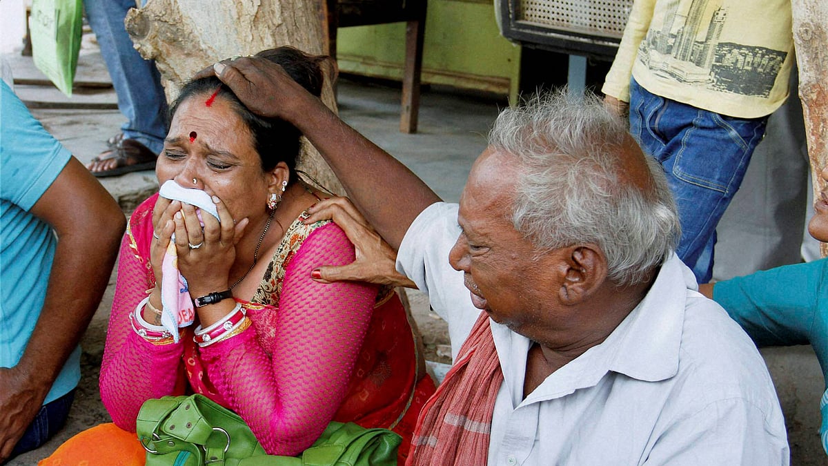 Relatives of the convicts of the Gulberg society massacre cry outside the SIT court after the announcement of quantum of sentence in Ahmedabad on Friday. (Photo: PTI)