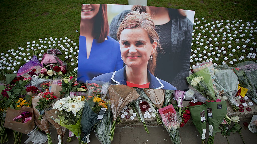 An image and floral tributes for Jo Cox, lay on Parliament Square, outside the House of Parliament in London, Friday. (Photo: AP)