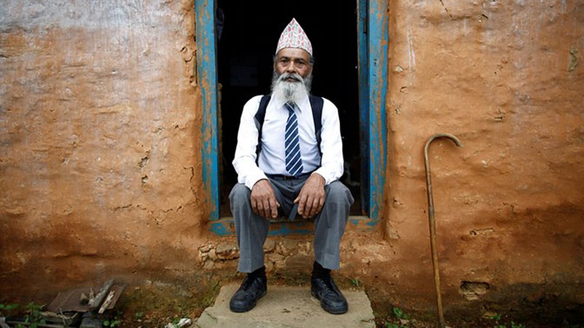 Durga Kami, 68, ready to walk down for an hour to attend his Grade 10 classes at the local school in Nepal. (Photo: Reuters/Navesh Chitrakar) 