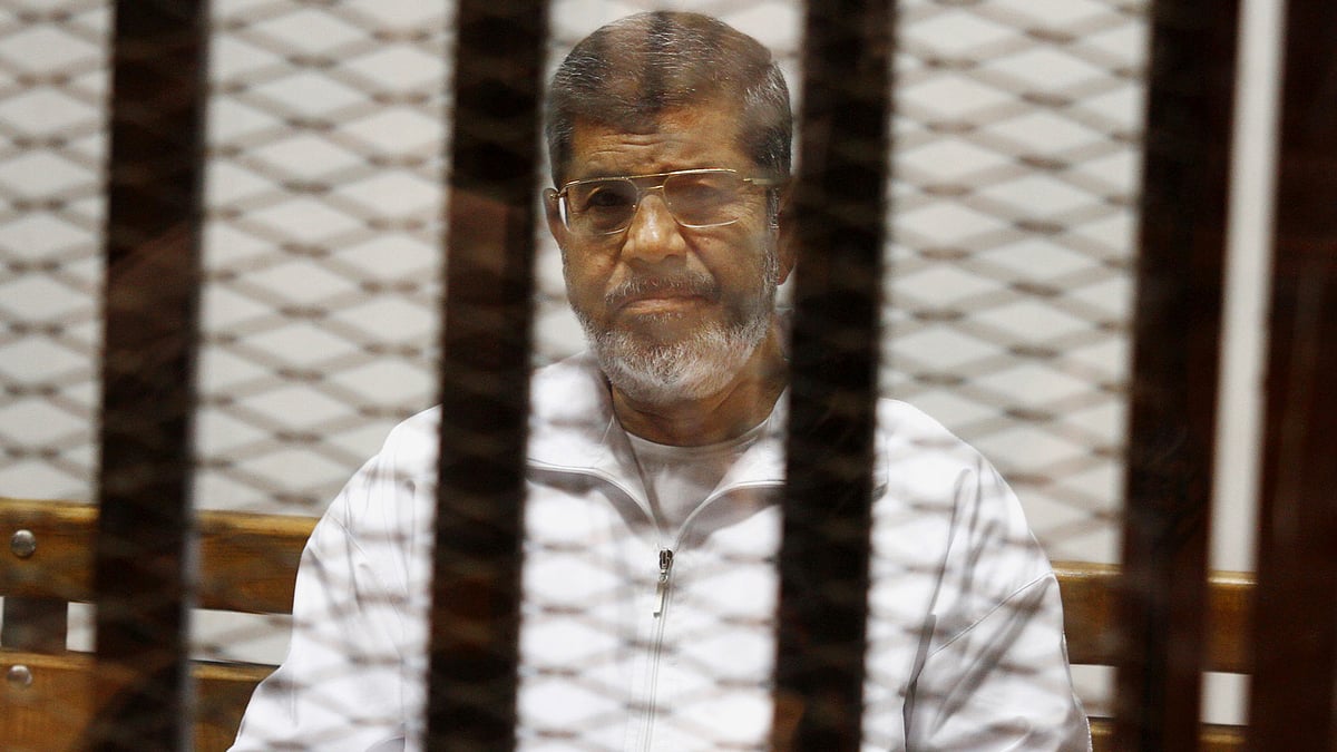 Egypt’s ousted Islamist President Mohammed Morsi sits in a defendant cage in Cairo. (File Photo: AP)