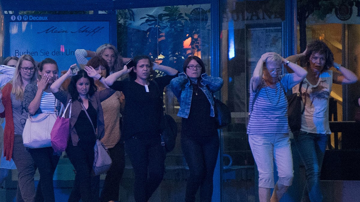 People leave the Olympia mall in Munich, southern Germany, Friday, 22 July, 2016 after several people have been killed in a shooting. (Photo: AP)