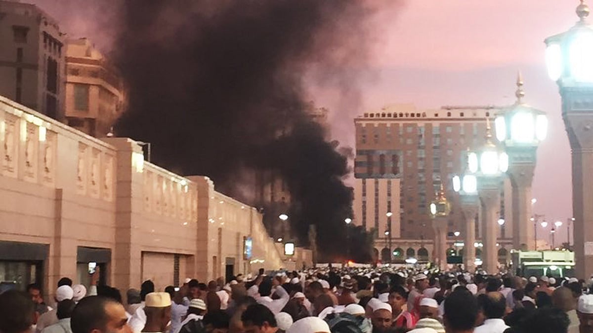 People stand by an explosion site in Medina, Saudi Arabia on Monday. (Photo: AP)