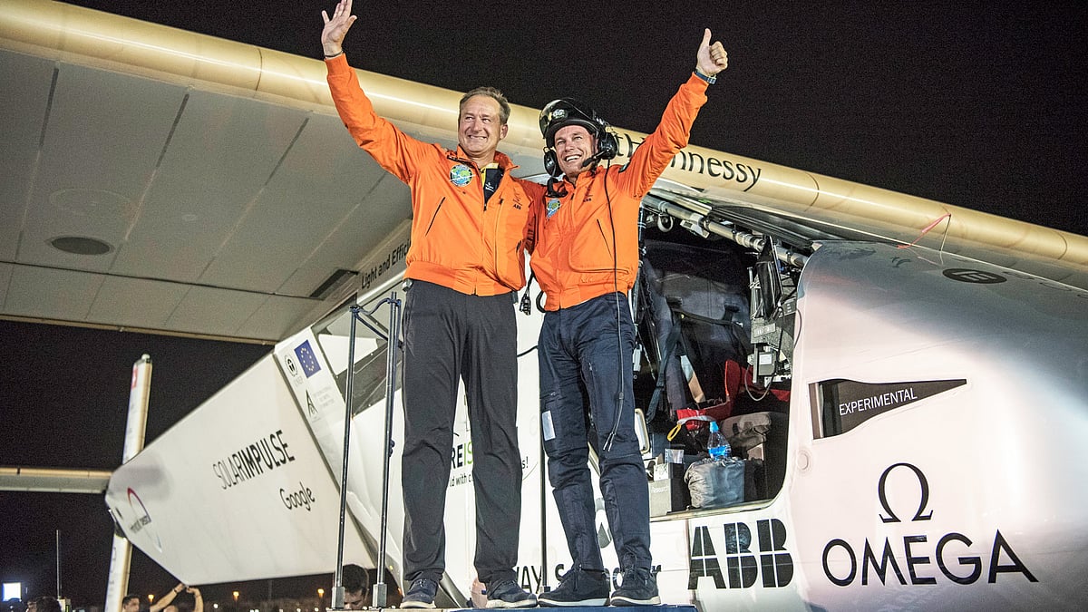 Pilots Bertrand Piccard(R) and Andre Borschberg celebrate the landing of their plane at an airport in Abu Dhabi, United Arab Emirates. (Photo: AP)