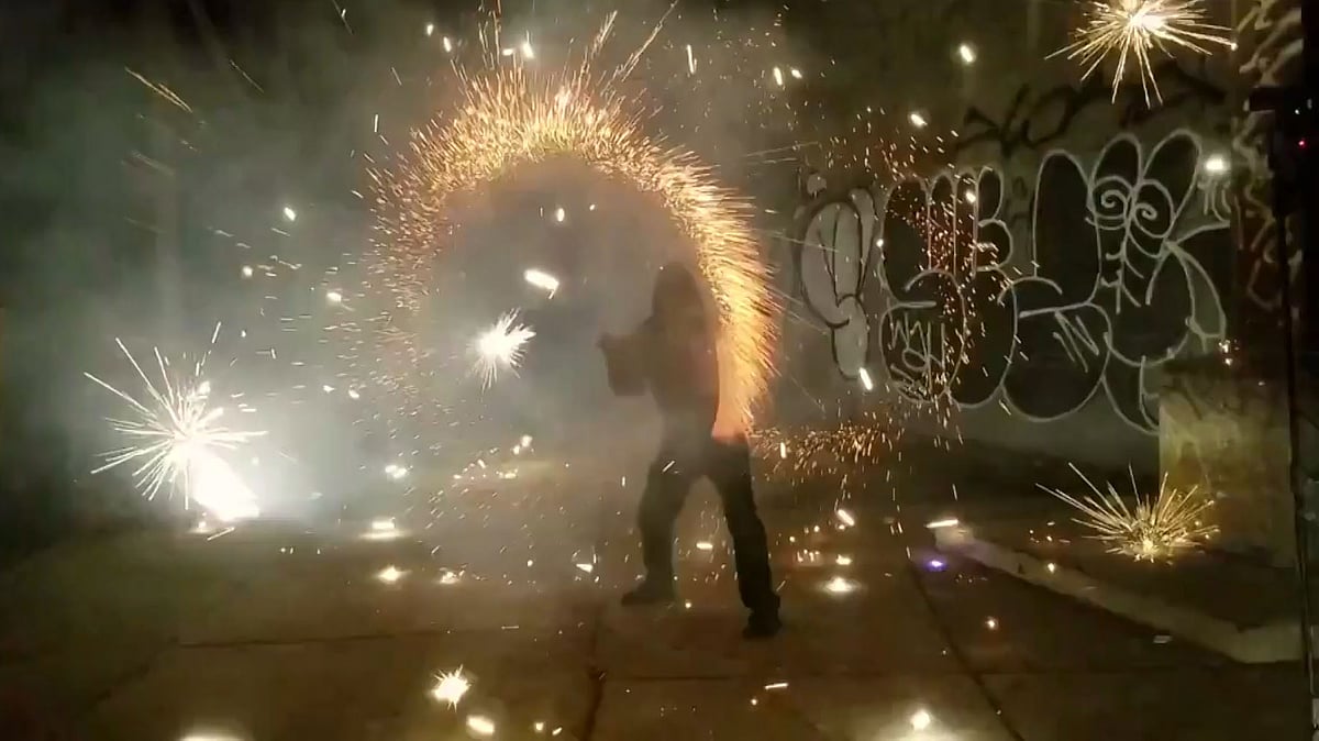 Artist Andrew Stoicu performs purple rain with fire (Photo: AP/Newsflare Screengrab)