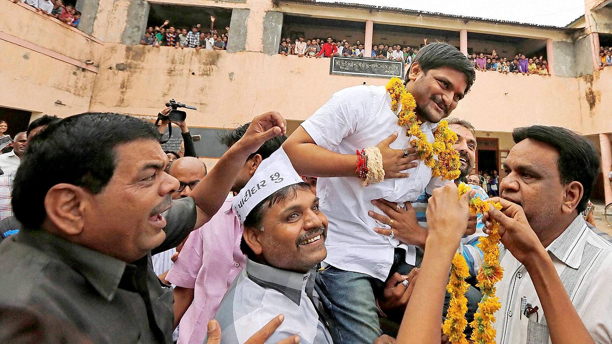 File Photo: People welcome PAAS convener Hardik Patel on arrival at his home town Viramgam some of 65 Kms from Ahmedabad on Saturday. 