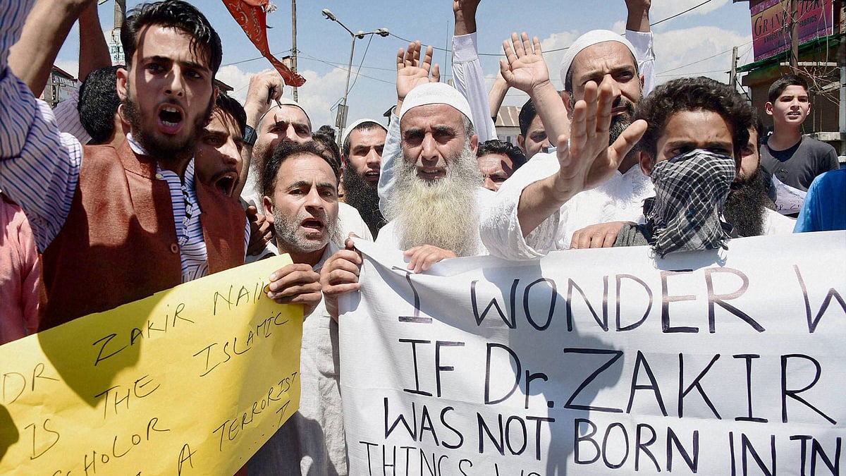 Supporters shout slogans and hold placards during a protest march in favour of Islamic scholar Zakir Naik in Srinagar on Friday. (Photo: PTI) 