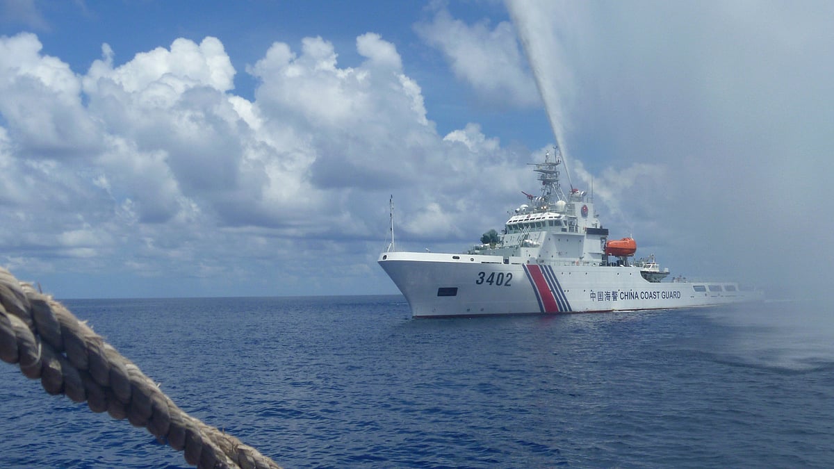 Chinese Coast Guard members approach Filipino fishermen as they confront each other off Scarborough Shoal in the South China Sea. (Photo: AP)