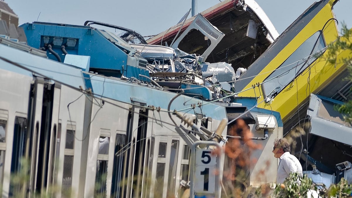 A man watches the scene of a train accident after two commuter trains collided head-on near the town of Andria, in Italy. (Photo: AP)