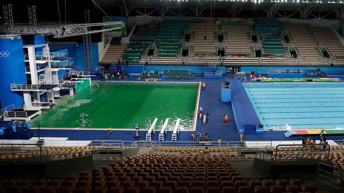The water of the diving pool appears a murky green, in stark contrast to the pool’s previous day’s color and also that of the clear blue water in the second pool for water polo at the venue as divers train in the Maria Lenk Aquatic Center at the 2016 Summer Olympics in Rio de Janeiro, Brazil, Tuesday, Aug. 9, 2016. (AP Photo/Matt Dunham)