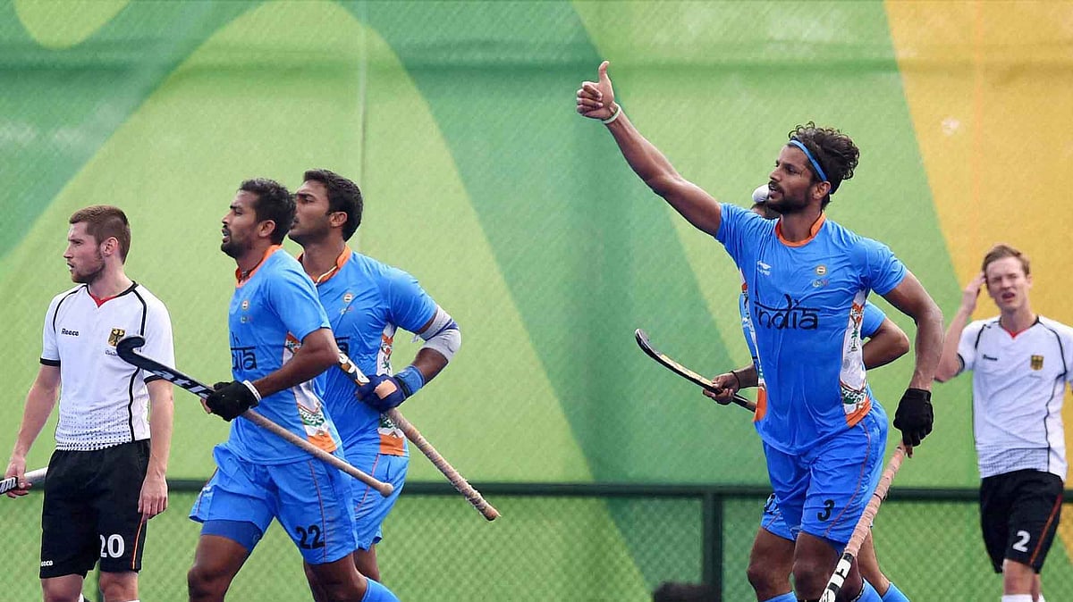 Rupinder Pal Singh gestures to the stands after scoring the equaliser against Germany in the Pool B match at the Olympics. (Photo: AP)