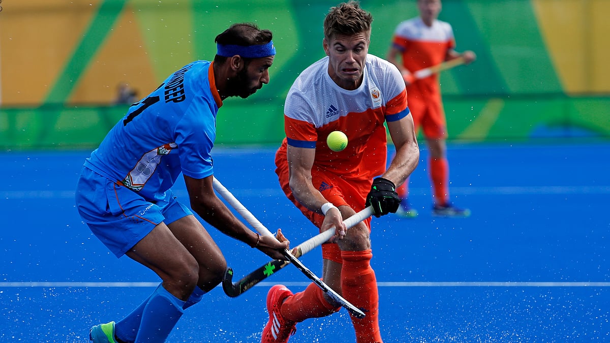 India’s Ramandeep Singh, left, fights for the ball with Netherlands’ Sander De Wijn during a men’s field hockey match at the 2016 Summer Olympics in Rio de Janeiro, Brazil. (Photo: AP)