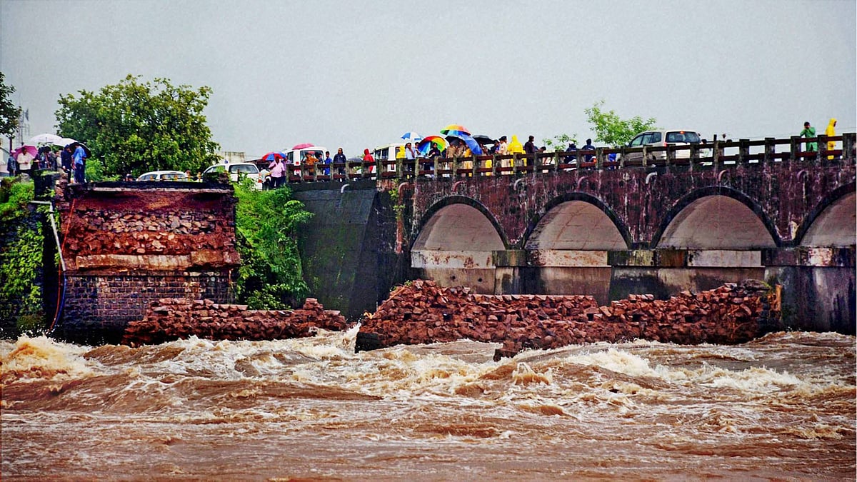 The remaining portion of washed away Mahad-Poladpur bridge by the flood waters of Savitri river on the Mumbai-Goa highway in Raigad district on Wednesday. (Photo: PTI)