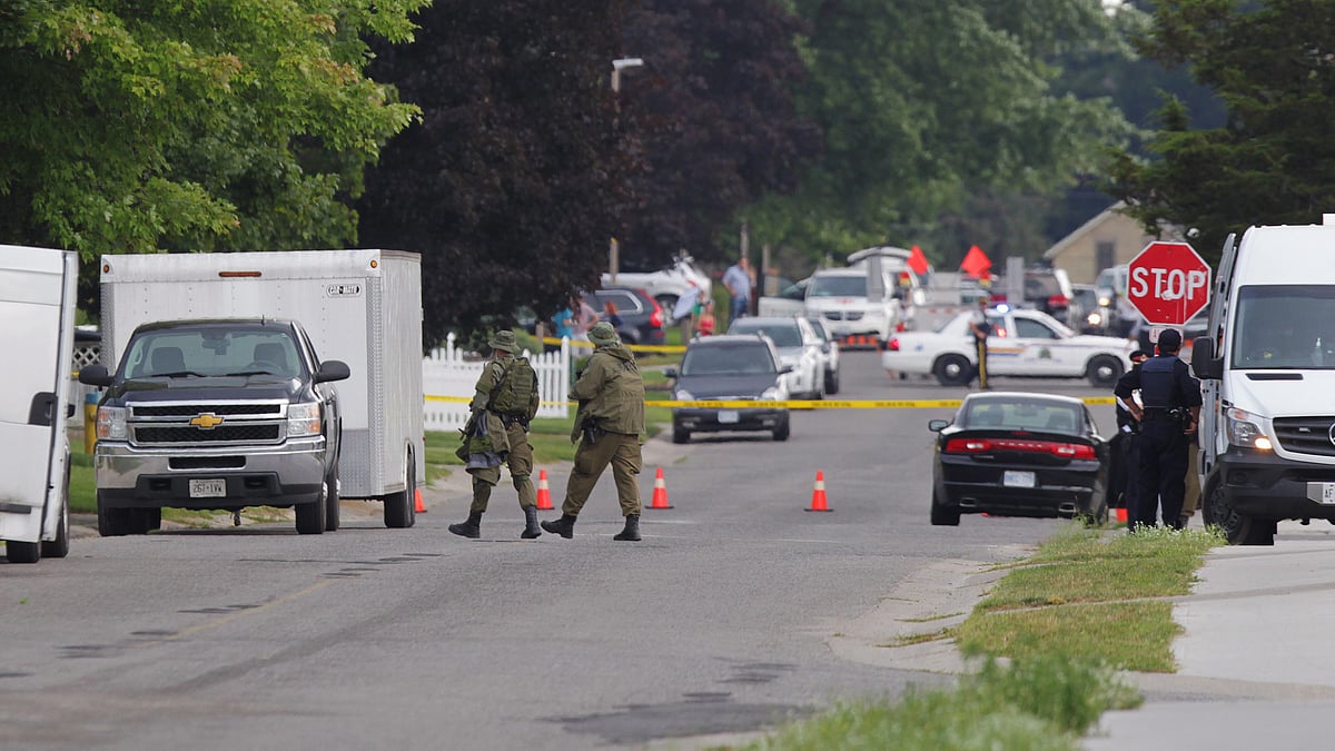 Police gather evidence outside of a house, a day after a stand-off with authorities in Ontario, Canada. (Photo: Reuters)