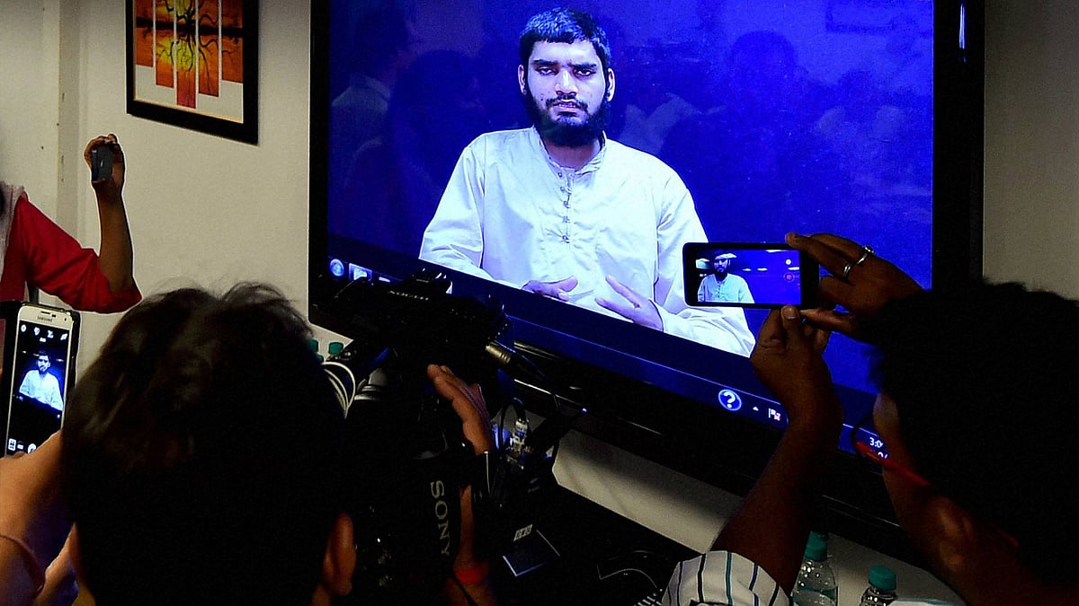 Media persons taking image of Lashkar-e-Taiba terrorist Bahadur Ali from a screen, who was arrested by NIA on 25 July, during a press conference at NIA headquarter in New Delhi on Wednesday. (Photo: PTI)