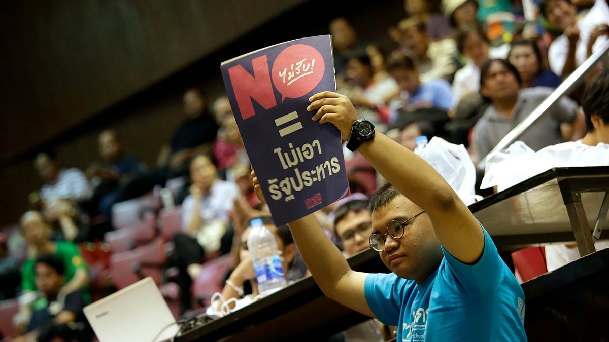 A Thai student holds a poster reading “vote no = no coup “ at Thammasat University in Bangkok. (Photo: AP)