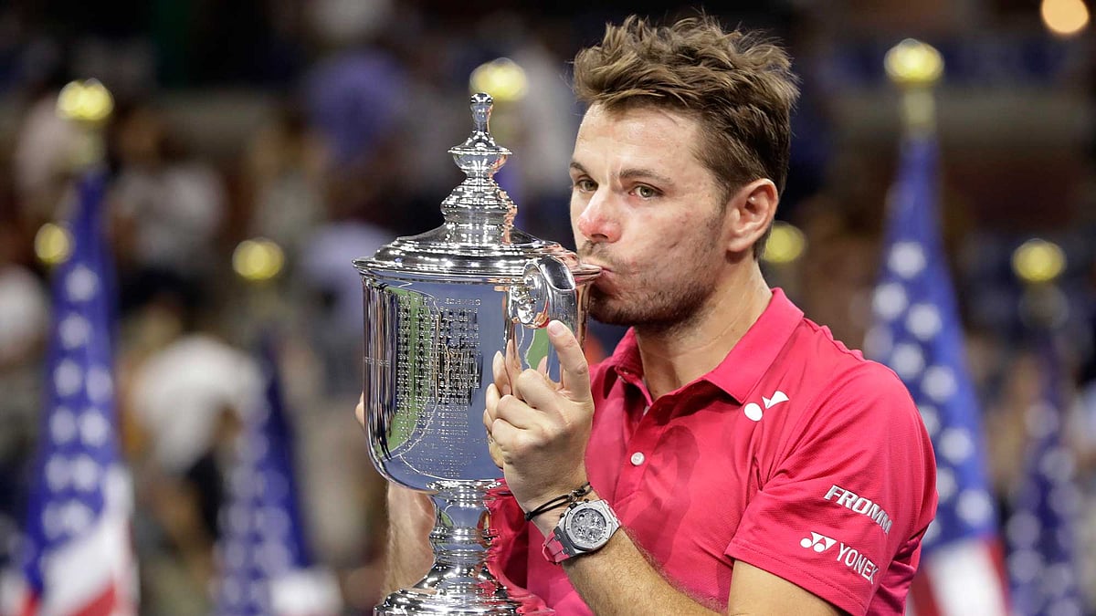 Stan Wawrinka, of Switzerland, holds up the championship trophy after beating Novak Djokovic, of Serbia, to win the men’s singles final of the US Open. (Photo: AP)