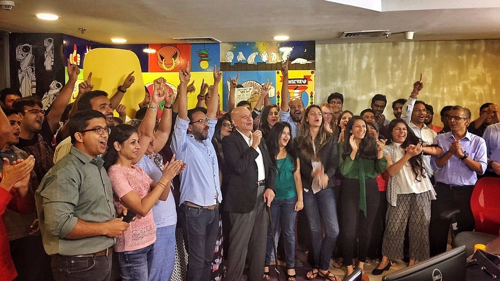 Team Quint celebrates in the newsroom.