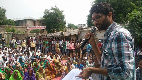 Jignesh Mevani at a rally in Dhokla where locals had planned to gherao the Taluka office to demand their land be allocated to them. (Photo Courtesy: <a href="https://www.facebook.com/DalitCameraDC/photos/pcb.1206365832755669/1206365696089016/?type=3&theater">Dalit Camera: Through Un-Touchable Eyes</a>)