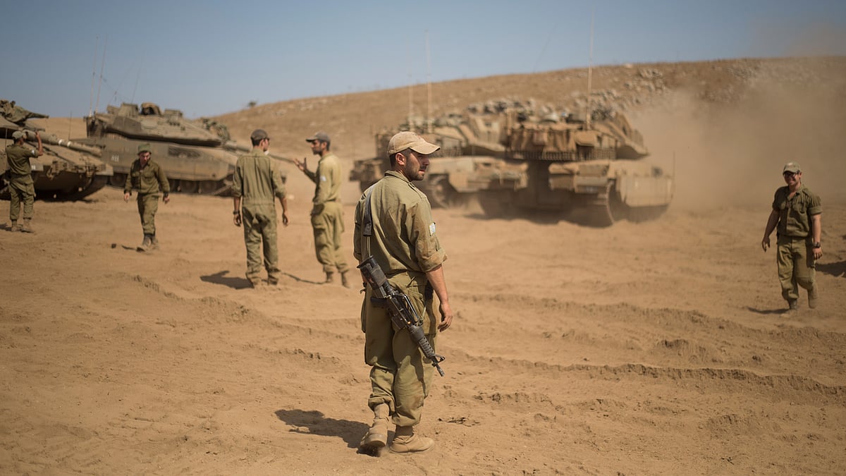 Israeli soldiers gather next to tanks during training in the Israeli-controlled Golan Heights, near the border with Syria. (Photo: AP)
