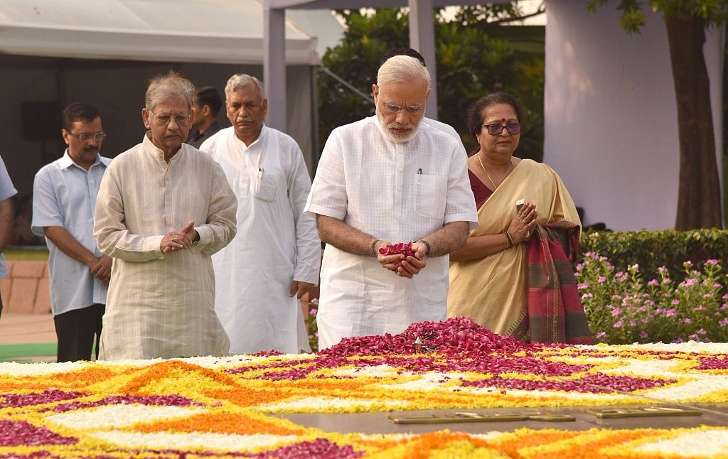 PM Modi pays homage to Mahatma Gandhi at Rajghat in Delhi on Sunday. (Photo: IANS)
