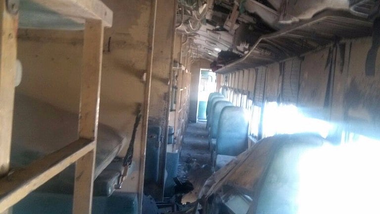 A damaged compartment of a passenger train is seen following twin blasts on a railway track in Mach district in Pakistan’s southwest Balochistan Province. (Photo: IANS)
