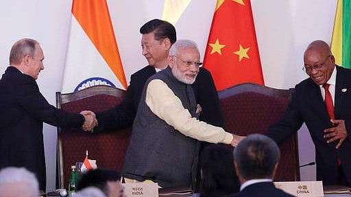 PM Modi (center front) shakes hand with South African President Jacob Zuma, as Russian President Vladimir Putin (left) shakes hand with Chinese President Xi Jinping at the end of the BRICS summit in Goa, India, Sunday, 2016. (AP Photo/Manish Swarup)