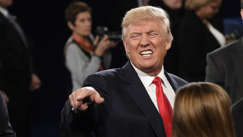 Republican US presidential nominee Donald Trump talks with a member of the audience at the conclusion of the second presidential debate on 9 October. (Photo: Reuters)