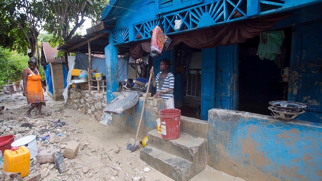 People in Haiti pick up after Hurricane Matthew. (Photo: AP)