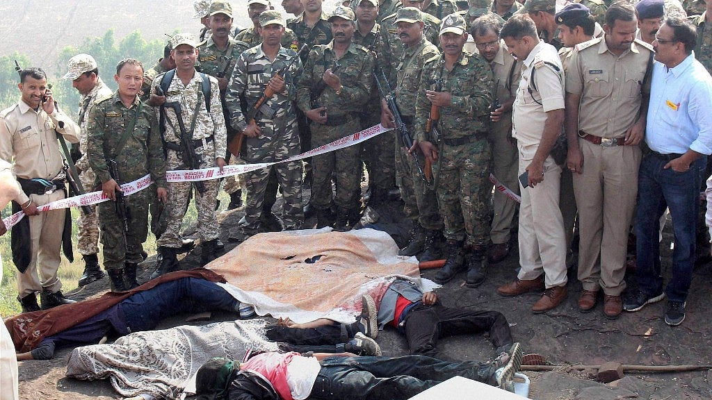  Police at the encounter site at the hillocks of Acharpura village after the STF killed 8 SIMI activists. (Photo: PTI)
