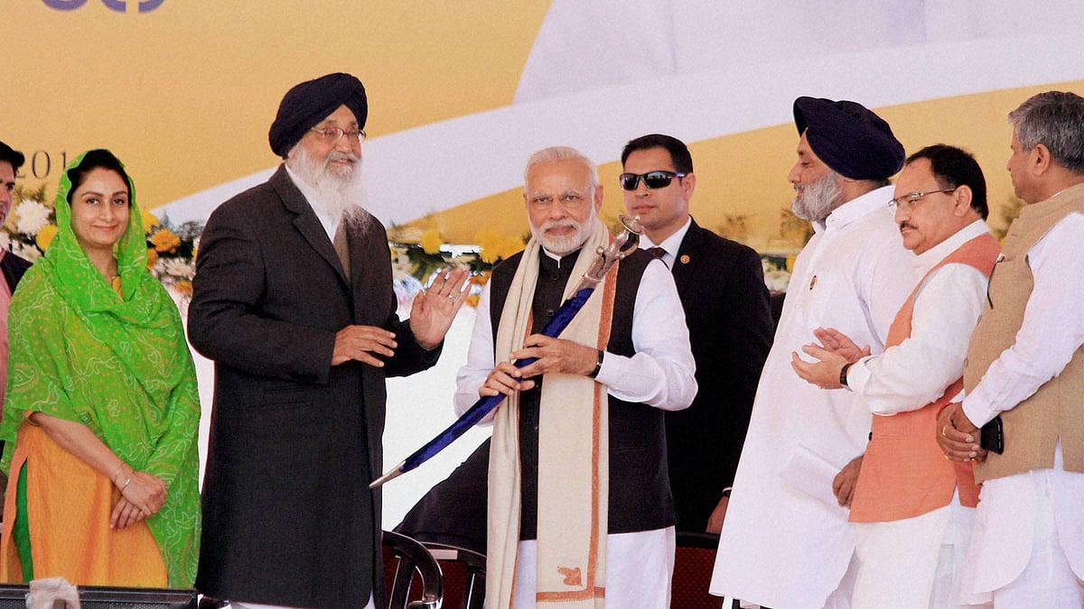 Prime Minister Narendra Modi is presented a sword by Punjab CM Parkash Singh Badal in Bathinda as Union Ministers JP Nadda, Harsimrat Kaur watch on. 