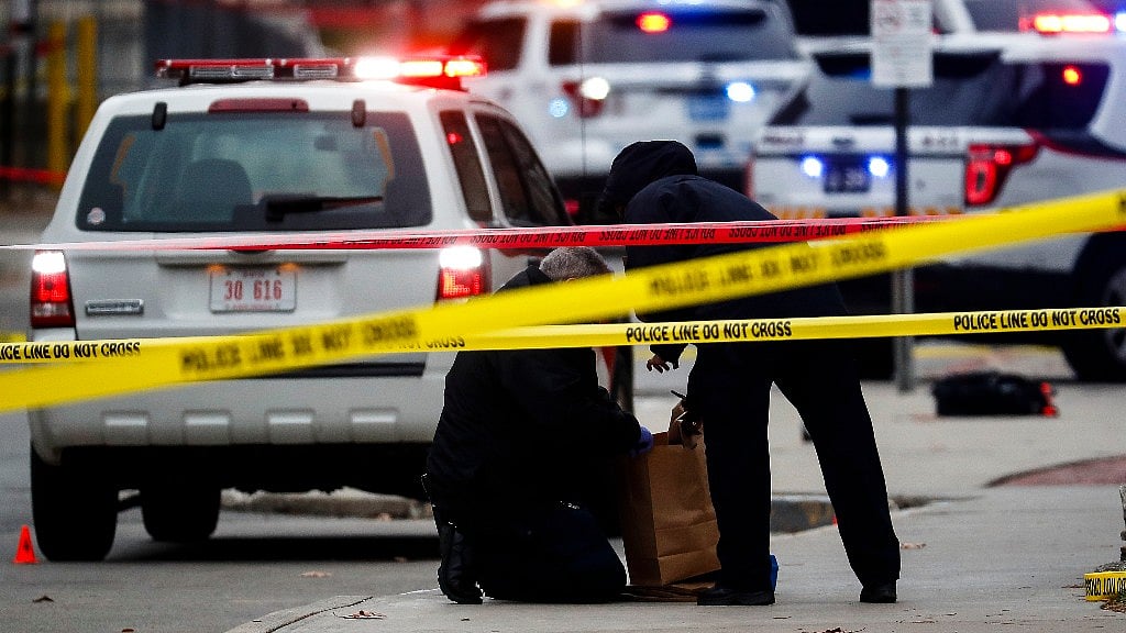 Crime scene investigators collect evidence from the pavement as police respond to an attack on campus at Ohio State University on Monday. (Photo: AP)