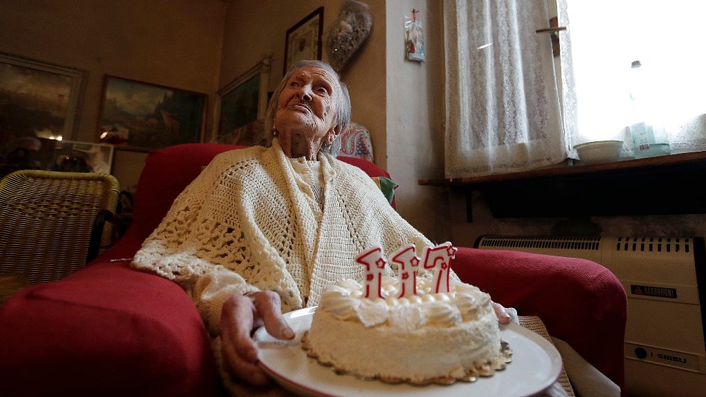 Emma Morano holds a cake with candles marking 117 years in the day of her birthday in Verbania, Italy (Image: AP)
